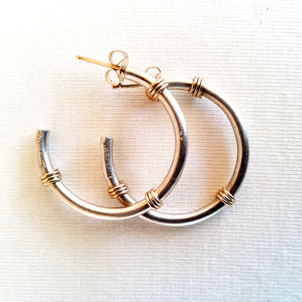 Tiffany and Co. sterling silver and 585 14K yellow gold coil hoop earrings